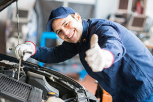 auto mechanic at work on a car in his garage